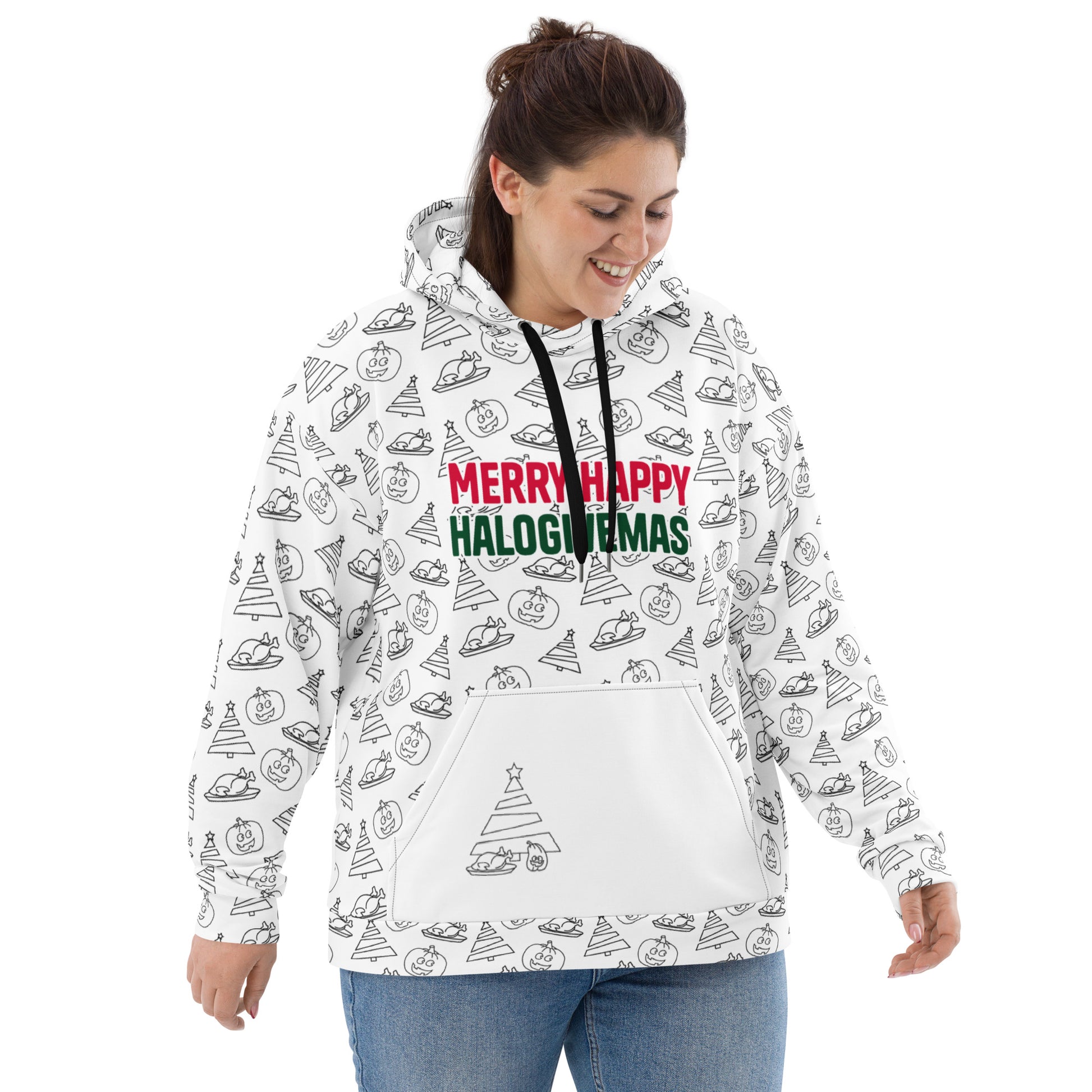 A smiling woman wearing her white hoodie, which is covered in a fun, festive print including Christmas trees, pumpkins, a Thanksgiving turkey and the words 'Merry Happy Halogivemas' in holiday colors.