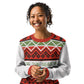 An African American woman with curly hair and a bright smile models a festive holiday sweater. The sweater is adorned with traditional Christmas patterns in red, green, and white, featuring geometric diamonds, zigzags, and rows of Christmas trees. A central white stripe proudly displays the phrase 'TIS THE SEASON.' in green. She clasps her hands together, exuding a joyful and relaxed holiday spirit, perfectly complementing the cheerful design of the sweater.