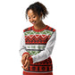 A joyful African American woman with curly hair smiles softly while modeling a holiday sweater. The sweater boasts a festive design with layers of geometric patterns, including diamonds and Christmas trees, in shades of red, green, and white. 'TIS THE SEASON' is emblazoned across the middle in bold green letters. Her relaxed demeanor and the cheerful sweater design perfectly capture the festive spirit of the season.