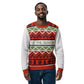 An African American man with a beard smiles warmly while modeling a festive holiday sweater. The sweater features a vibrant array of Christmas patterns in red, green, and white, including geometric diamonds and rows of Christmas trees. A white band across the chest boldly states 'TIS THE SEASON.' in green. The man's casual pose and friendly expression convey a joyful holiday spirit, complemented by the classic seasonal design of the sweater.