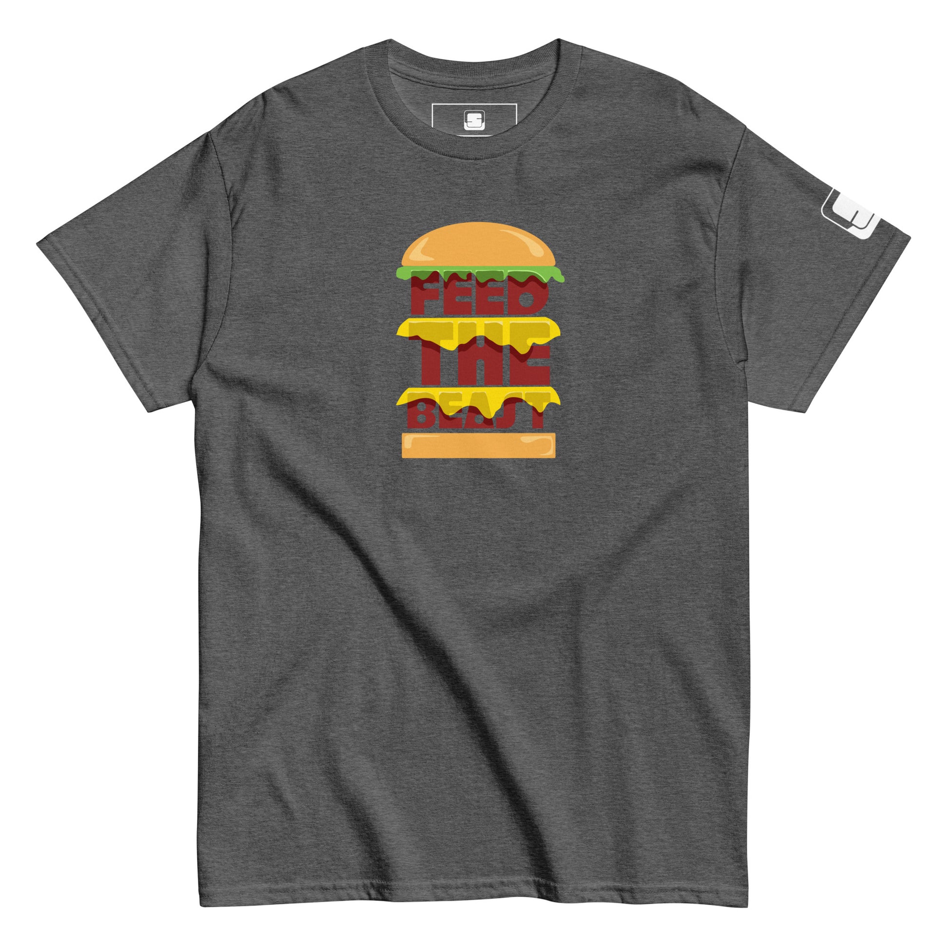 Dark heather t-shirt with 'FEED THE BEAST' in bold, stacked yellow and red lettering embedded in a detailed burger graphic, featuring a small logo patch on the sleeve, presented on a plain white background.