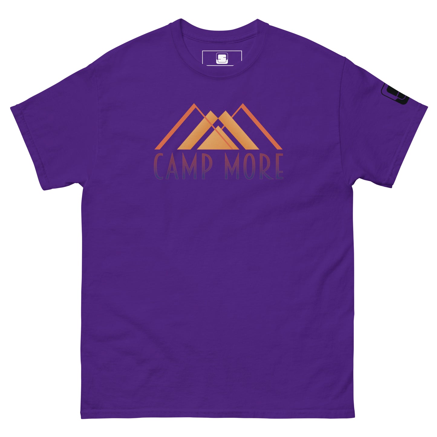 Purple t-shirt laid flat showcasing the 'CAMP MORE' slogan in purple with an orange mountain range illustration, complete with a black logo patch on the sleeve, isolated on a white background.