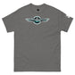 A flat lay image of a cool gray Shapetrix Entertainment t-shirt. The shirt features a stylized logo in the center, with the company name in teal and white lettering encased in a black circle, flanked by white wing designs. The t-shirt has a relaxed fit, and a visible tag on the left sleeve adds a touch of branding detail. The overall aesthetic is modern and casual.