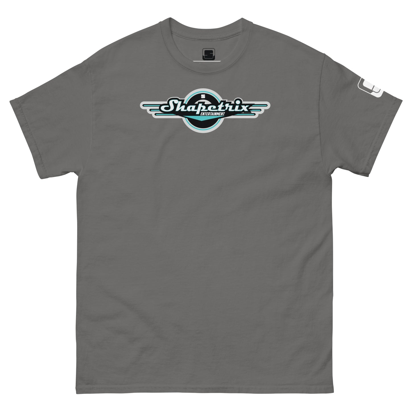 A flat lay image of a cool gray Shapetrix Entertainment t-shirt. The shirt features a stylized logo in the center, with the company name in teal and white lettering encased in a black circle, flanked by white wing designs. The t-shirt has a relaxed fit, and a visible tag on the left sleeve adds a touch of branding detail. The overall aesthetic is modern and casual.