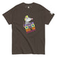 A dark brown t-shirt featuring a quirky and colorful design of a possum with a neon green mohawk, jamming on a purple boombox. The illustration includes the fun phrase "ROCK 'UM POSSUM" in vibrant, playful lettering below the image. The t-shirt's creative graphic blends retro and modern styles, aimed at music and animal lovers with a sense of humor.