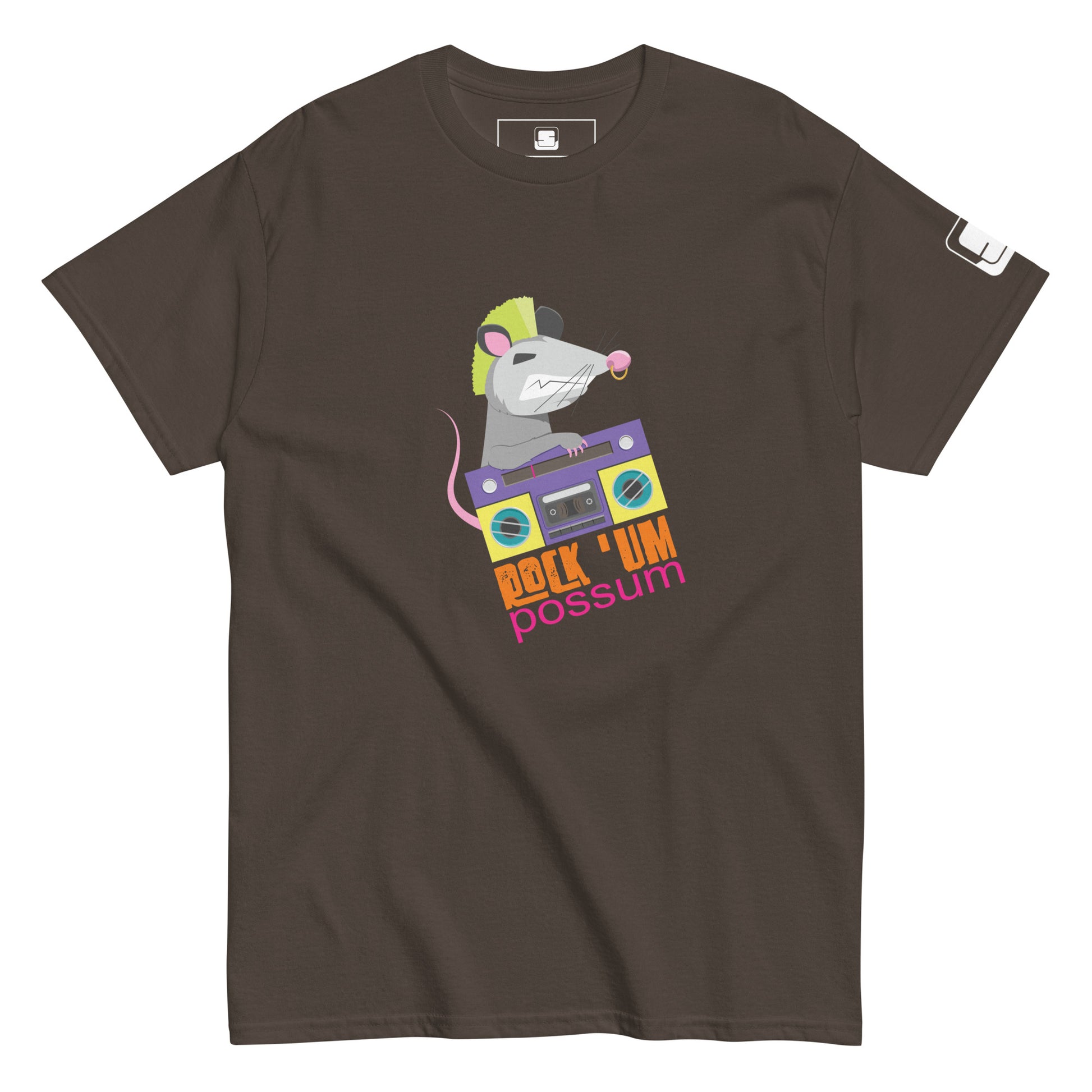 A dark brown t-shirt featuring a quirky and colorful design of a possum with a neon green mohawk, jamming on a purple boombox. The illustration includes the fun phrase "ROCK 'UM POSSUM" in vibrant, playful lettering below the image. The t-shirt's creative graphic blends retro and modern styles, aimed at music and animal lovers with a sense of humor.