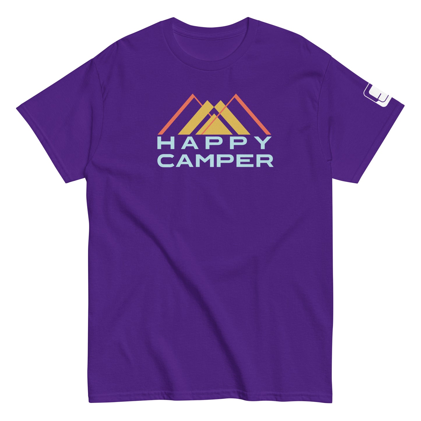 A vibrant purple t-shirt featuring the  a colorful mountain motif with three overlaid peaks in muted shades of yellow and orange, and the phrase "HAPPY CAMPER" beneath in a bold, pale blue sans-serif font. The t-shirt has a casual, crew neck style with a sleeve tag, presented on a plain white background to emphasize the design's details.