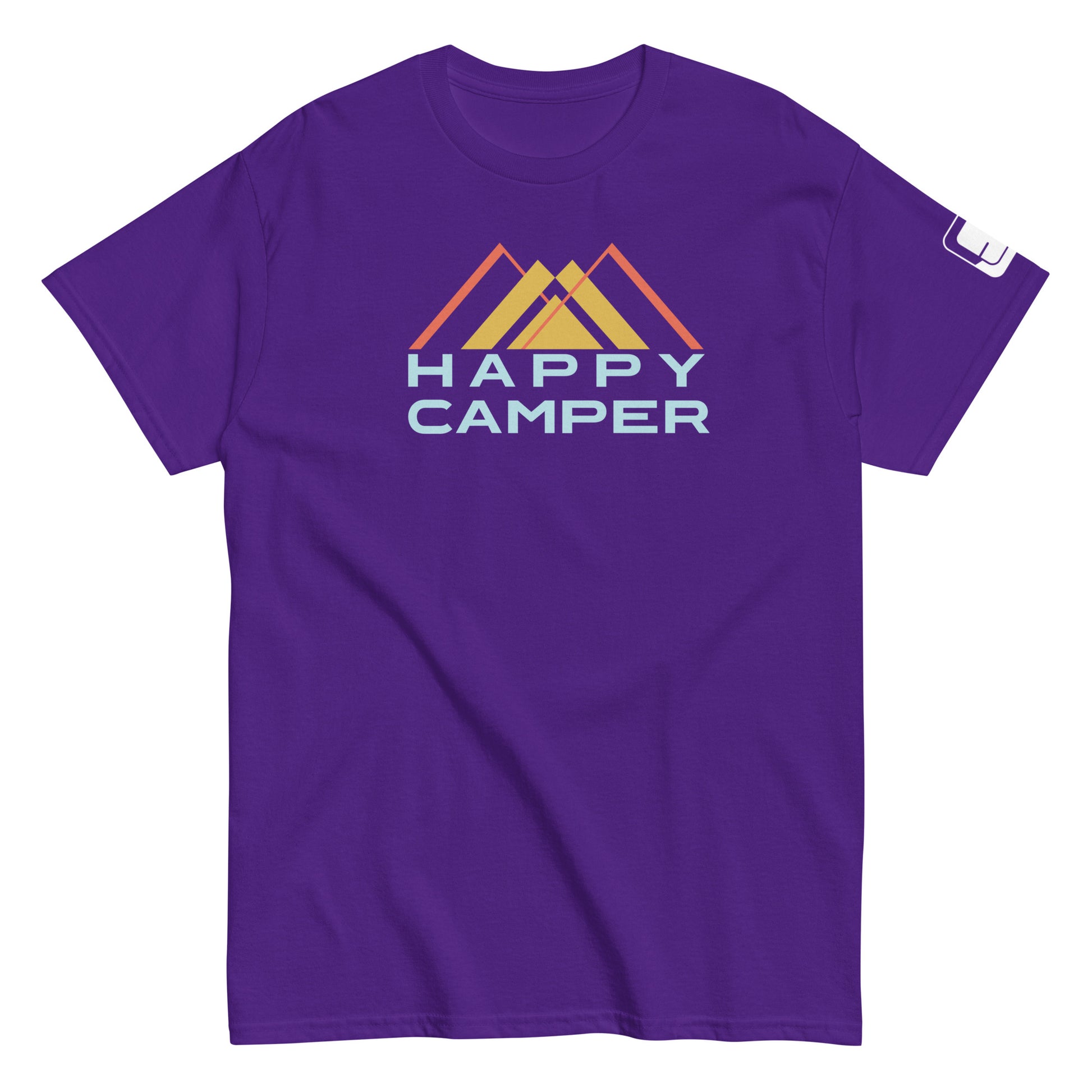 A vibrant purple t-shirt featuring the  a colorful mountain motif with three overlaid peaks in muted shades of yellow and orange, and the phrase "HAPPY CAMPER" beneath in a bold, pale blue sans-serif font. The t-shirt has a casual, crew neck style with a sleeve tag, presented on a plain white background to emphasize the design's details.