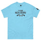 The image features a light blue t-shirt with the phrase "I'm Your Huckleberry" printed in black in a Western-style font, accompanied by an illustration of two crossed revolvers beneath the text. The design evokes a classic Western motif, suggesting themes of old-school bravery or confrontation. A small logo patch is visible on the sleeve, adding a contemporary detail to the otherwise vintage-inspired shirt.