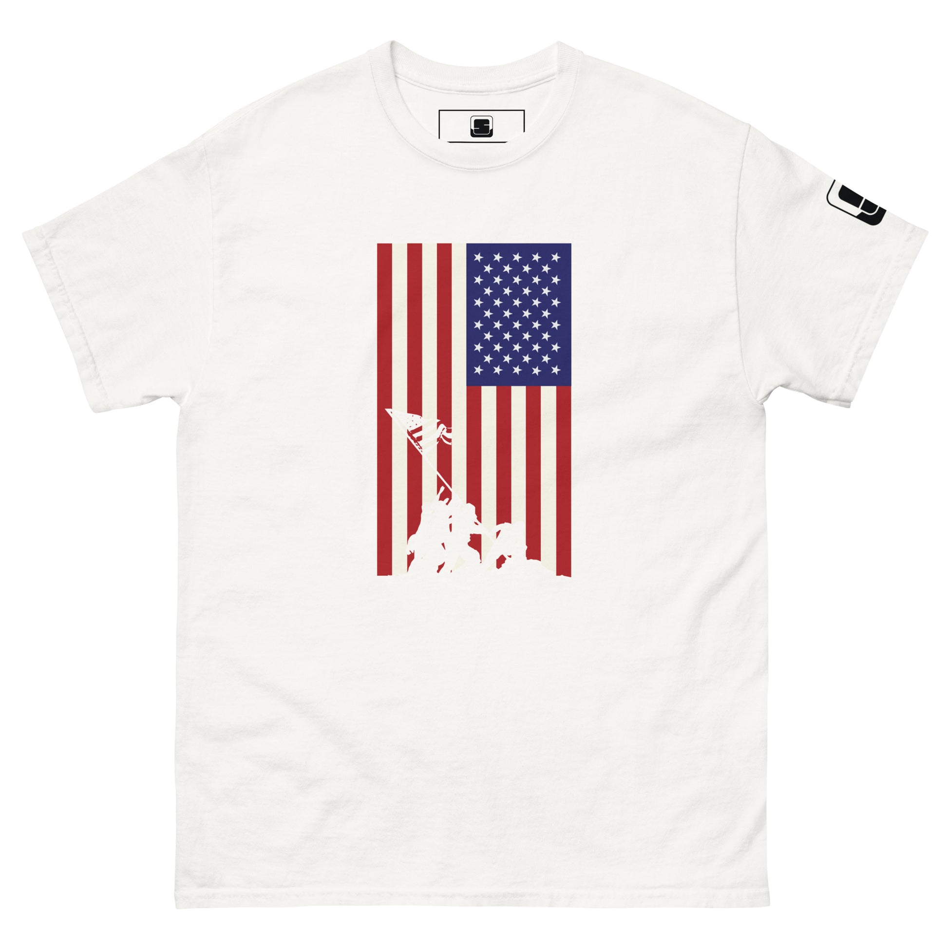 A white T-shirt showcases a vertical American flag design, consisting of a blue field with white stars on the top left, and alternating red and white stripes. Overlaying the bottom of the flag is a white silhouette of the famous Iwo Jima flag-raising scene, where soldiers are depicted in the act of raising the flag together, evoking a strong sense of patriotism and American heritage.