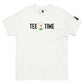 The image displays a plain white t-shirt laid flat and centered. On the chest area is printed "TEE TIME" in bold black letters, with a graphic of a golf ball on a tee and a small green tuft of grass below it. The t-shirt has a black square logo on the right sleeve. The background is a clean, solid white, ensuring the focus remains on the t-shirt's graphic and design.