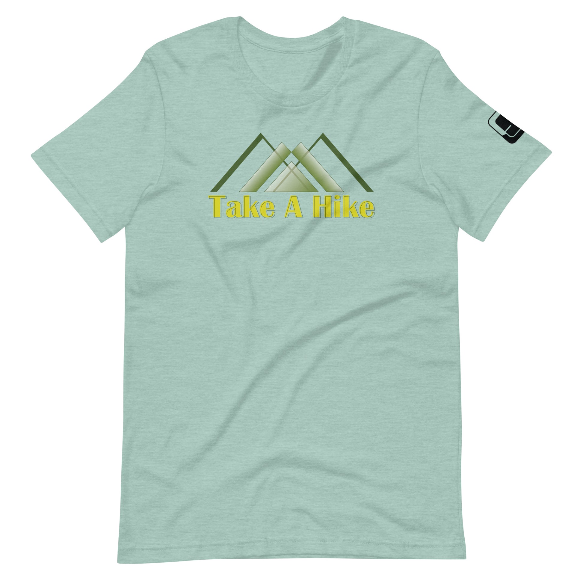 A pale green t-shirt displays a central graphic featuring stylized green mountain peaks with a yellow text below reading "Take A Hike." The shirt has a casual fit with short sleeves and a round neckline, and includes a small black logo patch on the right sleeve. The design is centered on the chest, making it a clear focal point for an outdoor-themed look.