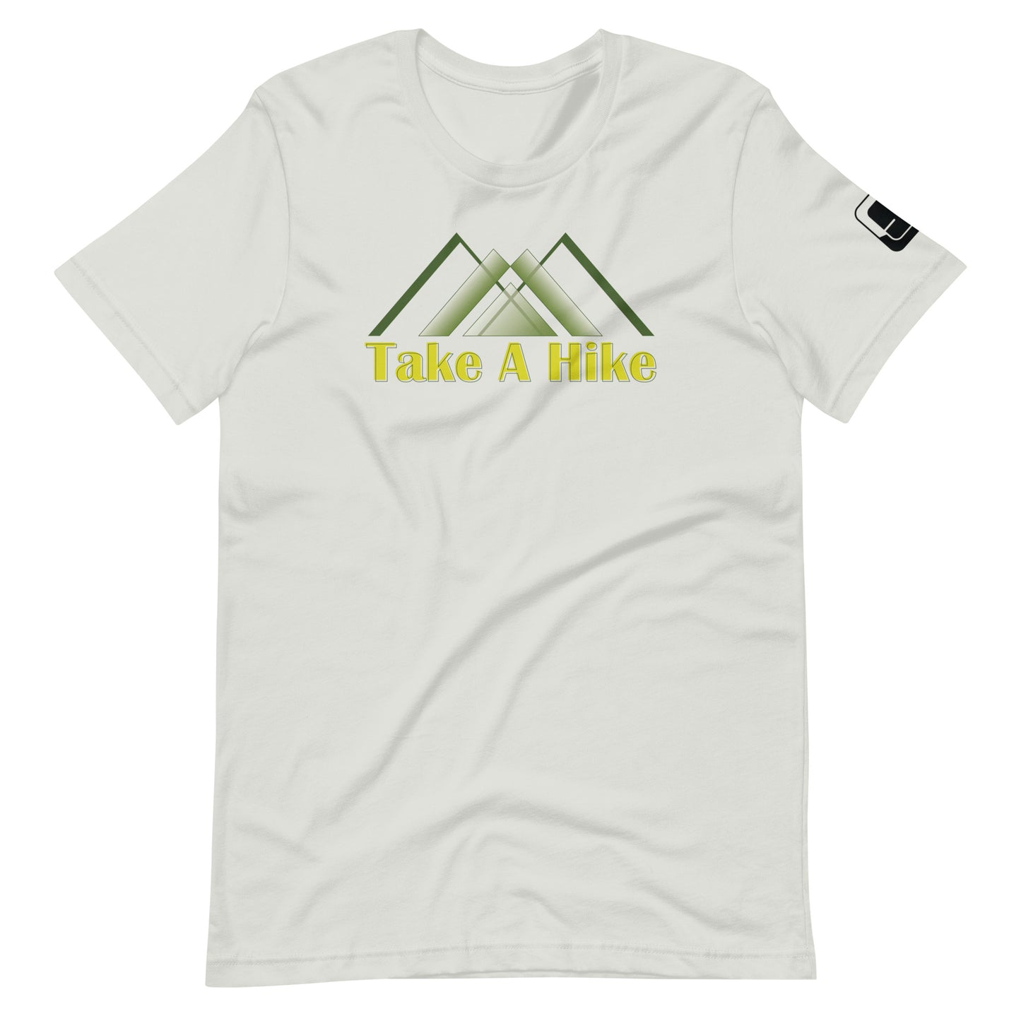 A light grey t-shirt featuring a stylized design of green mountains above the phrase "Take A Hike" in bold, yellow text. The graphic includes three overlapping mountain peaks, creating a clean, geometric look. The t-shirt has a crew neck and short sleeves with a small black logo patch on the right sleeve. The design is showcased against a white background, emphasizing the shirt's outdoor-themed graphic.