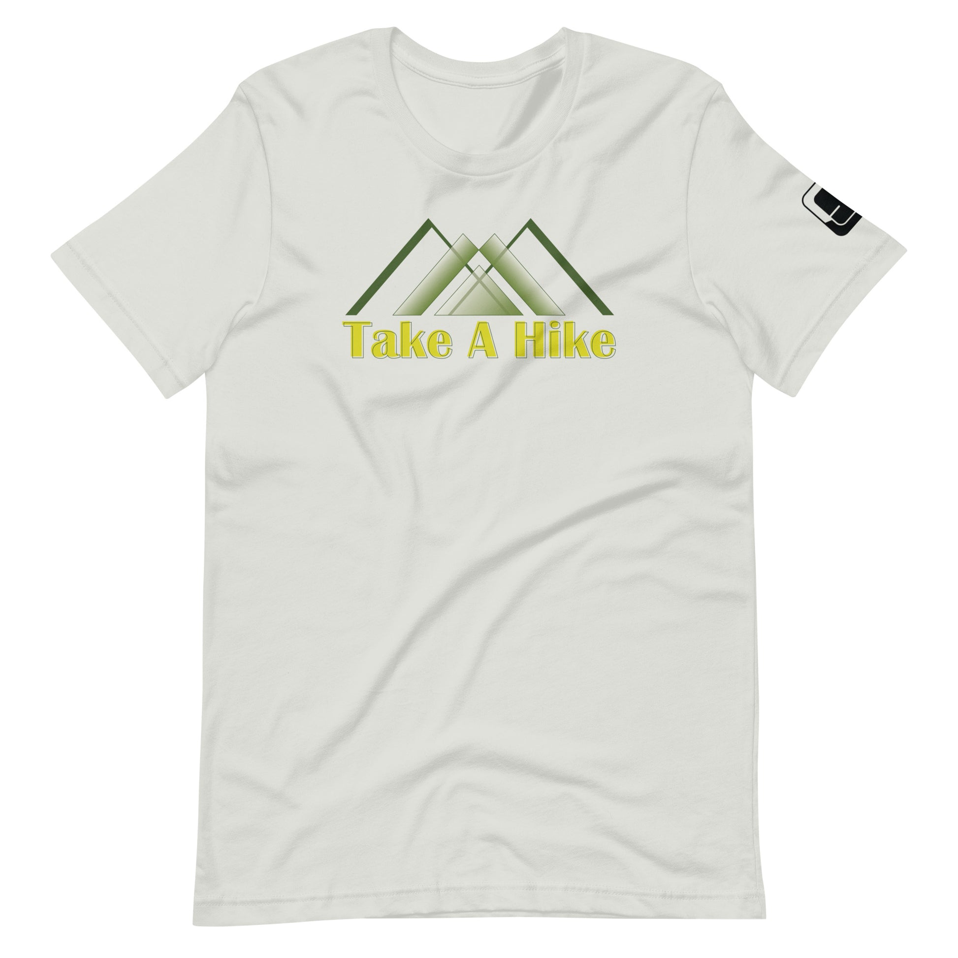 A light grey t-shirt featuring a stylized design of green mountains above the phrase "Take A Hike" in bold, yellow text. The graphic includes three overlapping mountain peaks, creating a clean, geometric look. The t-shirt has a crew neck and short sleeves with a small black logo patch on the right sleeve. The design is showcased against a white background, emphasizing the shirt's outdoor-themed graphic.